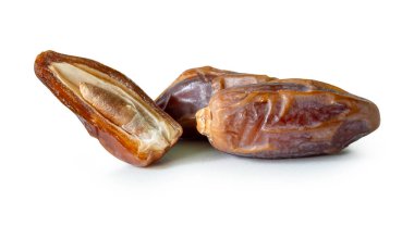 Olgun kurumuş hurma meyveleri yığının yarısı beyaz arka planda kırpma yolu ile izole edilir. Müslümanlar için Ramazan ayında iftar yemeği kavramı