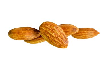 Brown almond nuts in stack are isolated on white background with clipping path.
