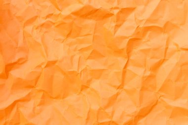 Üst görünüm ve buruşmuş veya buruşmuş turuncu kağıdın tam çerçevesi buruşuk turuncu kağıt arka plan dokusu olarak kullanılır.