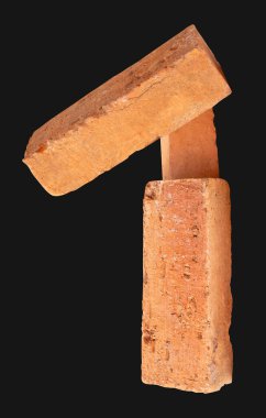 Yığındaki üç çatlamış kırmızı ya da turuncu tuğlanın yan görünümü kırpma yolu ile siyah arkaplanda izole edilmiştir..
