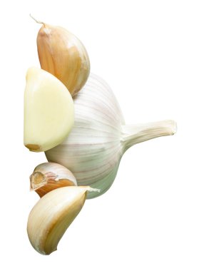 Garlic bulb with cloves in heap is isolated on white background with clipping path.