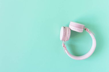 Nane yeşili arka planda pembe kulaklık. DJ kulaklıklar en üstte. Ses ve müzik dinleme.