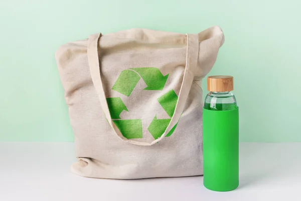 Natural cotton eco shopping bag and glass reusable water bottle.  Zero waste concept.