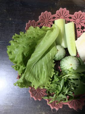 Dilimlenmiş salatalık, fesleğen, patlıcan, lahana ve ahşap tabakta uzun fasulyeler dahil çeşitli taze sebzeler. Sağlıklı gıda konsepti.