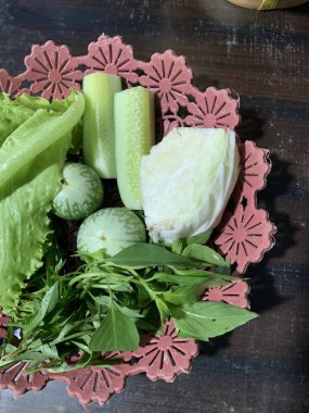 Dilimlenmiş salatalık, fesleğen, patlıcan, lahana ve ahşap tabakta uzun fasulyeler dahil çeşitli taze sebzeler. Sağlıklı gıda konsepti.