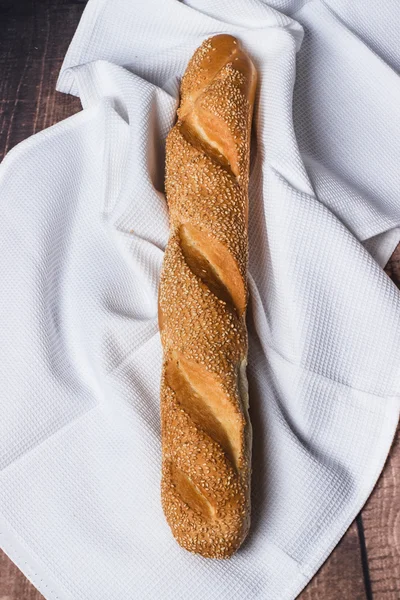 Fresh bread on a wooden surface — Stok fotoğraf