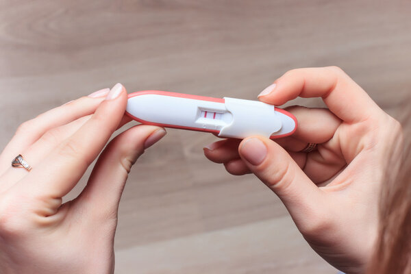 woman holding negative pregnancy test