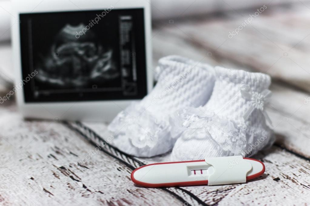 Young Woman Holding Baby Shoes And Positive Pregnancy Test Stock Photo By C Samoylova Lelya Mail Ua