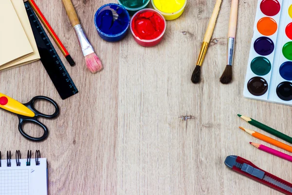 Un conjunto de papelería sobre fondo de madera, el lugar del artista — Foto de Stock