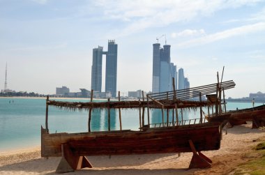 Old boat on the background of skyscrapers in Abu Dhabi clipart