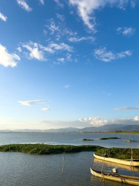 Peaceful Lakeside Scene with a Long Pier and Distant Mountains