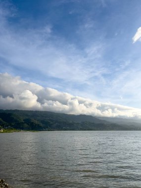 Scenic Lake Landscape with Clouds and Hills
