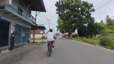 Banliyö yolunda bisiklete binen kişi