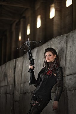 Raider Kız dünyada kıyamet sonrası, bir yaylı tüfek ile deri kostümlü.
