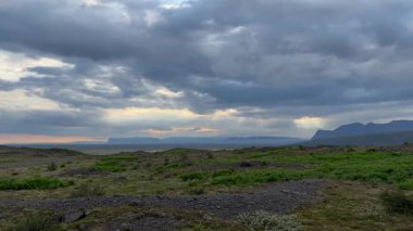 Çorak Çakıl Ovası İzlanda 'daki Fırtınalı Bulutların Altındaki Kar Kapaklı Dağlara çıkıyor. Yüksek kalite 4k görüntü