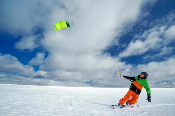 Спортсмен на сноуборде запускает воздушного змея — стоковое фото