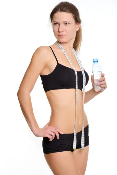 Sportswoman and clean drinking water in the bottle — Stok fotoğraf