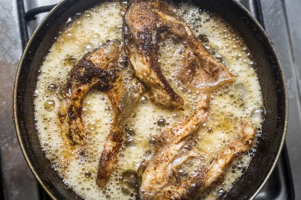 Fish frying in a pan — Stock Photo, Image