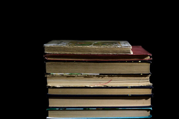 Stack of Old books on black surface