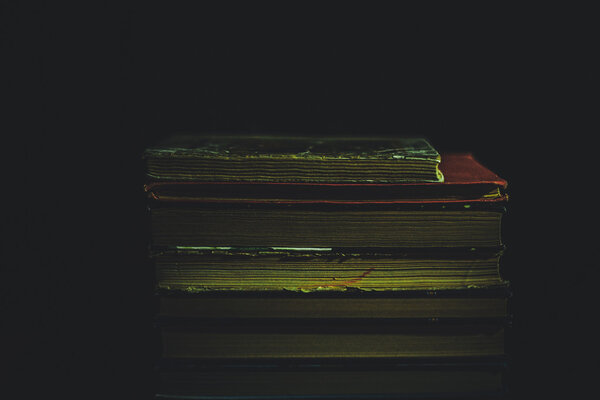 Stack of Old books on black surface
