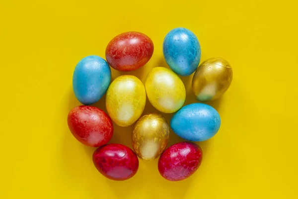 Colored Easter eggs on yellow — Stock Photo, Image