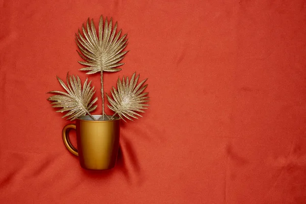 Decorative golden leaves on red textile backdrop — Stok Foto