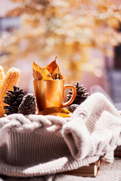 Corns, autumn leaves and coffee cup on windowsill — Stock Photo, Image