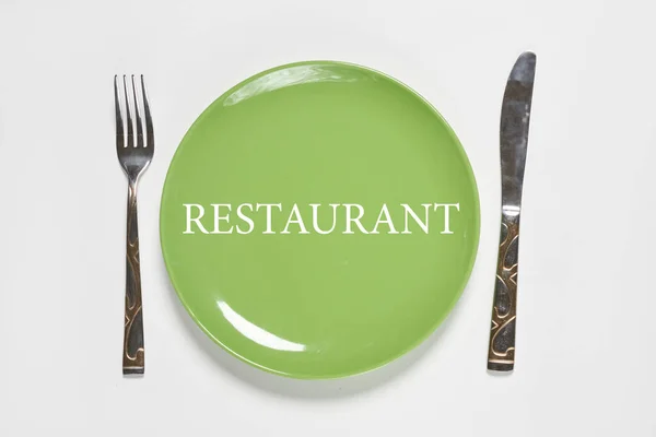 Green plate and fork with kitchen knife — Stock Photo, Image