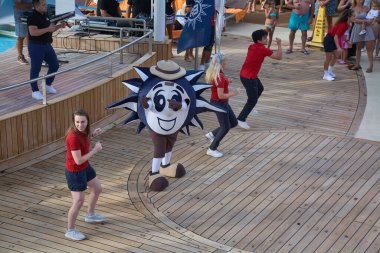 Venice. Italy - October 08, 2025: The MSC Cruises mascot, Doremi, dances with the entertainment team for passengers on the upper deck of the ship.