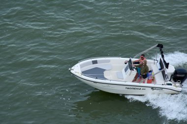 Venice. Italy - October 08, 2025: Four people enjoy a day of recreational boating in Venice, a popular pastime for locals and visiting tourists alike.
