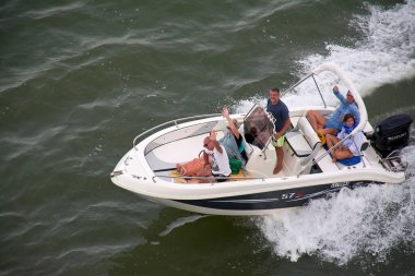 Venice. Italy - October 08, 2025: Five people on a boat excursion, an example of the adventure tourism and water sport activities available to visitors in Venice.