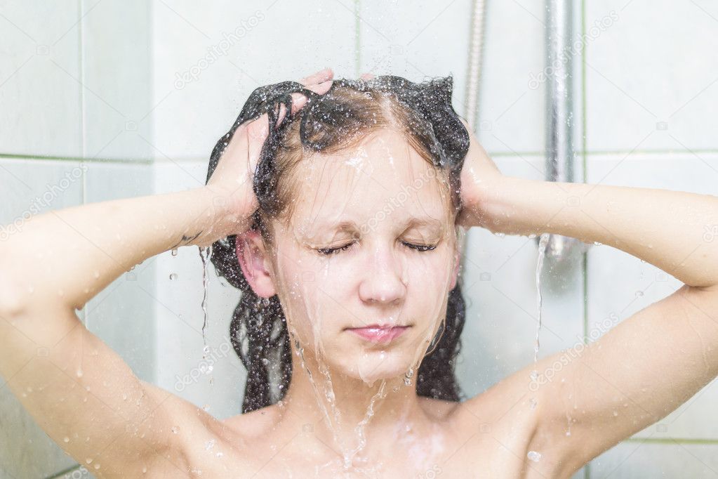 Woman washing her hair in hot shower