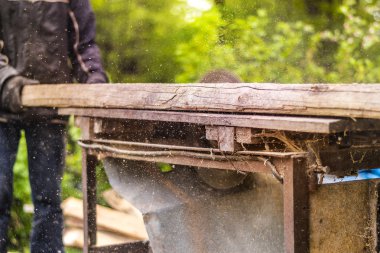Odun kesmek için dairesel kullanarak adam gördüm 