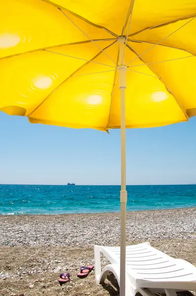 Sombrilla amarilla en la playa — Foto de Stock