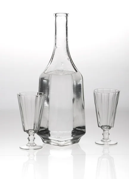 Two glasses and a decanter on grey white background — Stock Photo, Image