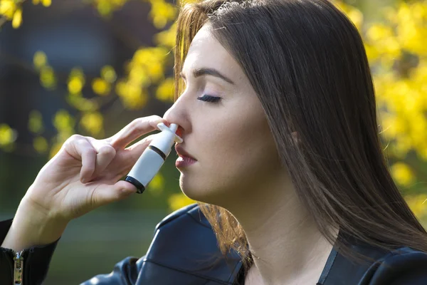 Allergy, girl using nose  inhaler — Stock Photo, Image