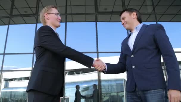 Two businessmen shaking hands — Stock Video