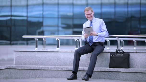 Young businessman having a video chat on digital tablet computer touchscreen — Stock Video