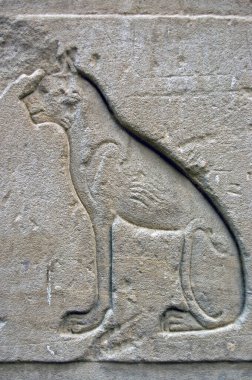 Ancient Egyptian carving of the cat, sometimes known as Bastet. Outer wall of the Temple of Horus at Edfu, Egypt. clipart