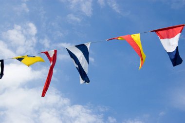 Naval signal flags fluttering in the sunshine.
