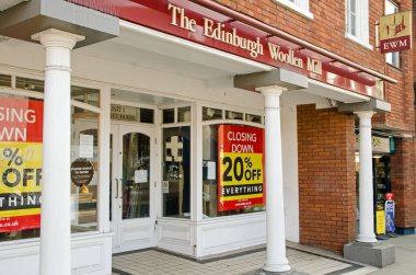 Wokingham, UK - February 28, 2021: Closing down sale at the Wokingham branch of clothes retailer Edinburgh Woollen Mill.  The brand has been in financial difficulty and a number of shops have been closed. clipart