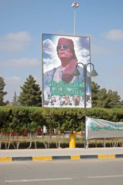 Tripoli, Libya - March 26, 2006: Giant poster of the dictator Colonel Gaddafi looming over the entrance to Tripoli Airport in Libya. clipart