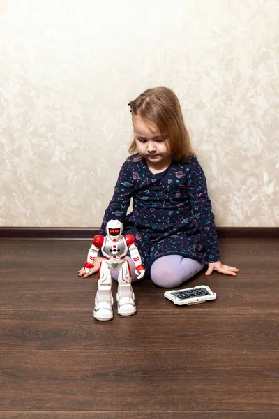 the child controls the robot from the remote control
