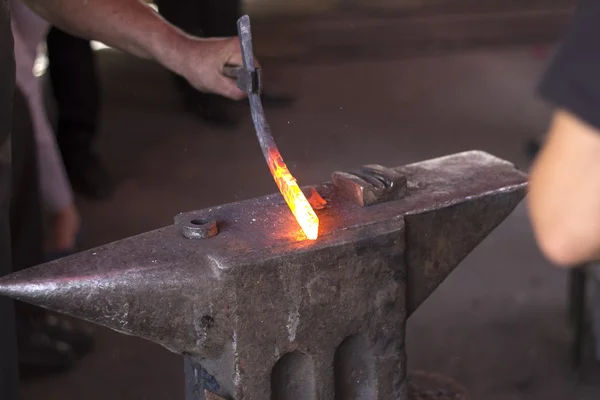 Blacksmith working with heated metal