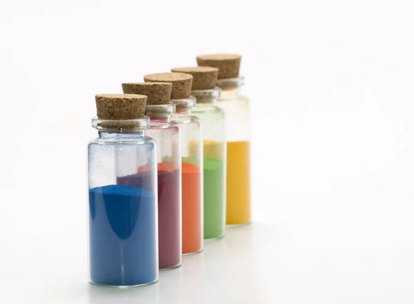 Colored powder in glass botles — Stock Photo, Image