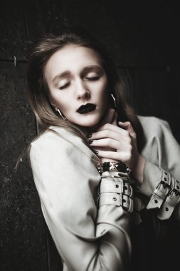 Young beautiful stylish girl walking and posing in city. Outdoor summer portrait of young classy woman black lips