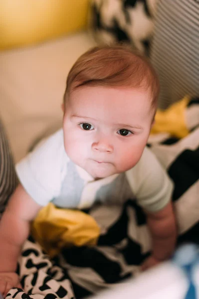 Close-up portrait of a cheerful cute baby in the crib at home — Stock Photo, Image