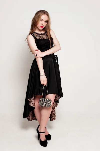 Portrait of beautiful young blonde girl in black dress. Fashion photo — Stock Photo, Image