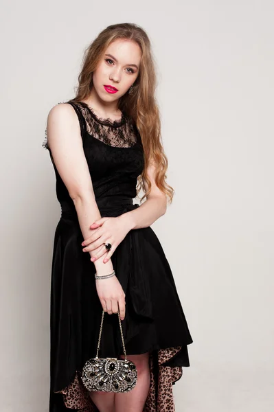 Portrait of beautiful young blonde girl in black dress. Fashion photo — Stock Photo, Image