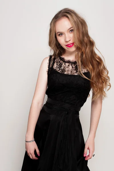 Portrait of beautiful young blonde girl in black dress. Fashion photo — Stock Photo, Image